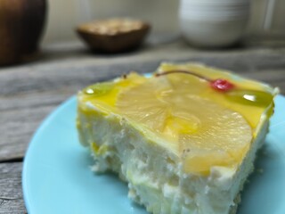 delicious piece of cake covered with pineapple and cherry, top view. High quality photos