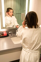 Beautiful girl in a Bathrobe posing in the interior of the room. Portrait of a cute beautiful girl in a white towel and Bathrobe. The morning of the procedure. High quality photo