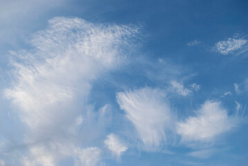 gentle white clouds in the blue sky