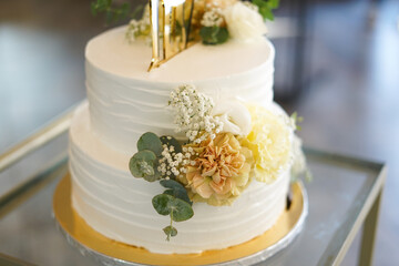 White wedding cake with yellow flowers. Close up. 