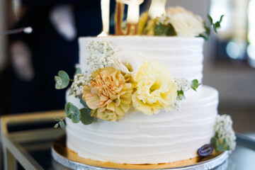 White wedding cake with yellow flowers. Close up. 