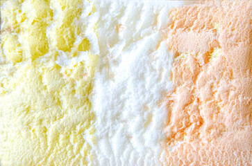 texture of yellow white and green ice cream like background, close up