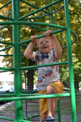 Little children run around and play in the playground.