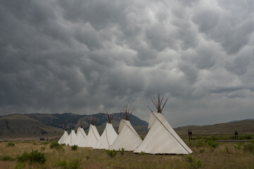 Dark Clouds Gather Over A Display Of Teepees In Gardiner © kellyvandellen