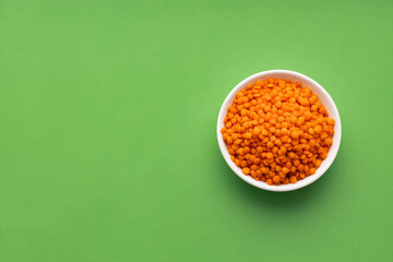Lens culinaris - Bowl of raw red lentils.
