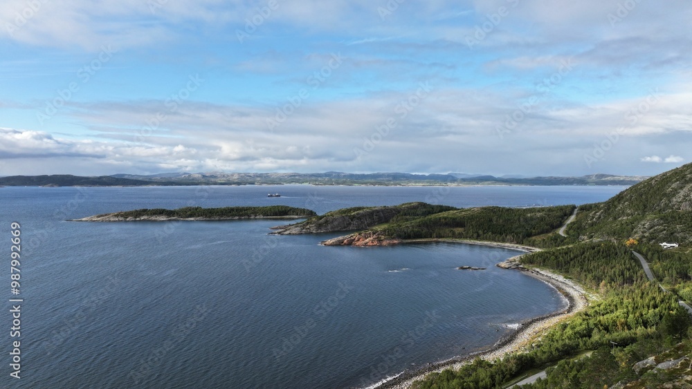 Canvas Prints Scenic coastal bay with clear blue skies and lush greenery