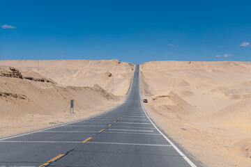 Road and High volt pole transmission tower in borders Xinjiang, Qinghai