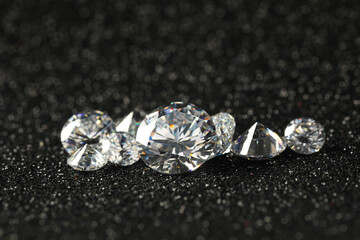 Beautiful dazzling diamonds on dark shiny background, closeup