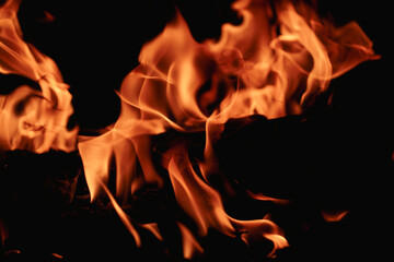 Fire over black background. Fire sparks background. Abstract blaze flames background. Burning fire....