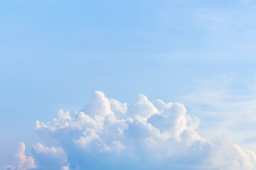 Late afternoon, cumulus clouds float in the blue sky.