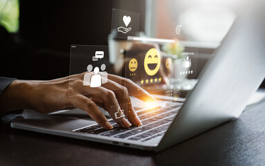 User Typing on Laptop to Submit Customer Feedback with Digital Satisfaction Ratings, Featuring...
