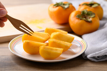 Sliced ripe persimmon ready to eating, Autumn fruit
