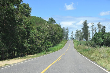 road with blue sky clear day paved highway with farms vegetation mountains clouds
