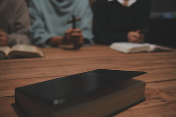 Fototapeta premium Christian group are praying to god with the bible and sharing the gospel. Concept of faith for god.