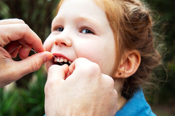girl having her teeth flossed