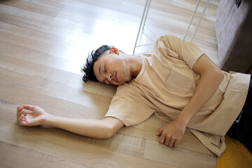 High Angle of Young Asian Man Fainted on The Floor at Home
