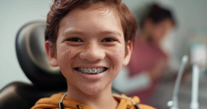 Face, happy and child patient with braces for dentist visit, checkup or dental cleaning at clinic. Portrait, orthodontics and boy with smile for teeth alignment treatment, oral care or consultation.