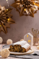 Homemade Christmas traditional cake pie with marzipan nuts and dried fruits pastry dessert stollen. Winter holidays season atmosphere. Delicious tasty composition home table setting Copy space