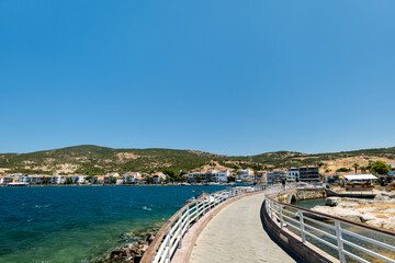 Obraz premium Eski Foca waterfront view by harbour on the Aegean coast, Izmir, Turkey. Eski Foca is a popular seaside resort town in Turkey