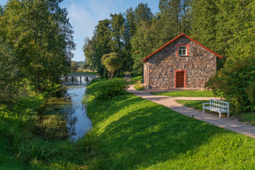 A traditional stone barn for storing flax on the shore of the pond 