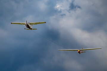 Plane towing a glider through the sky.
