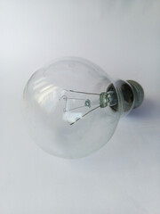 Incandescent lamp on white background close-up. Light sources in the house. Space for text. Power...