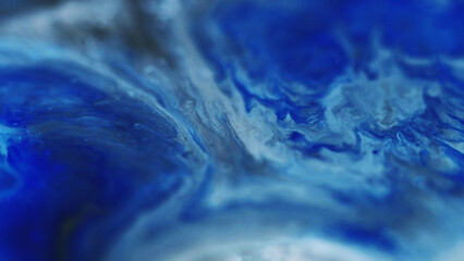 Ink wave. Glitter fluid spill. Defocused blue black color grain particles texture liquid mix flow abstract art background.