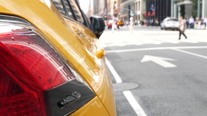 New York City. Yellow taxi car on Manhattan street. Taxi cab on Midtown Lexington avenue. Medallion taxicab rear view on Lex ave waiting for people or passengers on road. Urban scene in United States.
