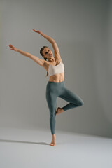 Graceful dancer performing an elegant pose in studio during a dance session