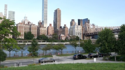 Obraz premium New York City waterfront skyline, Queensboro Bridge, Manhattan Midtown buildings, riverfront skyscrapers. Waterside cityscape view from Roosevelt Island. United States architecture and real estate.