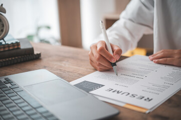 People are reviewing job applications before filling out their resume on the job application form in order to apply for a job at a company.