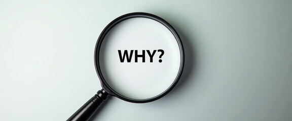Magnifying Glass Focusing on the Word "Why?"