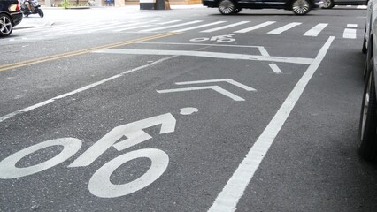 Bike lane asphalt sign, New York City. Bicycle path, cycle route for bicyclists, Manhattan. Way for roller skating and skates. Recreational sport activity infrastructure, biker cycling, United States.