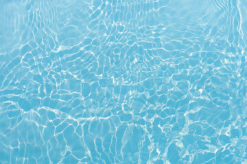 Blue water with ripples on the surface. Defocus blurred transparent blue colored clear calm water...