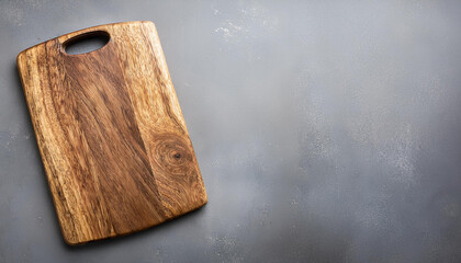 Fototapeta premium Old wooden cutting board on grey background. Top view. Copy space.