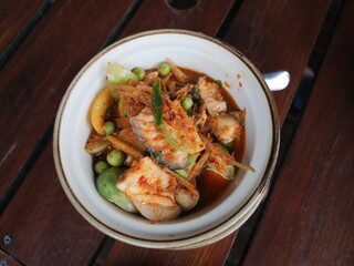 Spicy soup of fresh fillet fish mixed with red curry paste and sliced eggplant serving in the bowl. Famous hot and spicy soup menu in Thai restaurant. 
