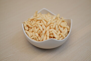telur gabus sticks in a bowl on wooden table