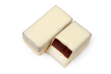 White chocolate candies with filling on a white background. A whole candy and half a candy.