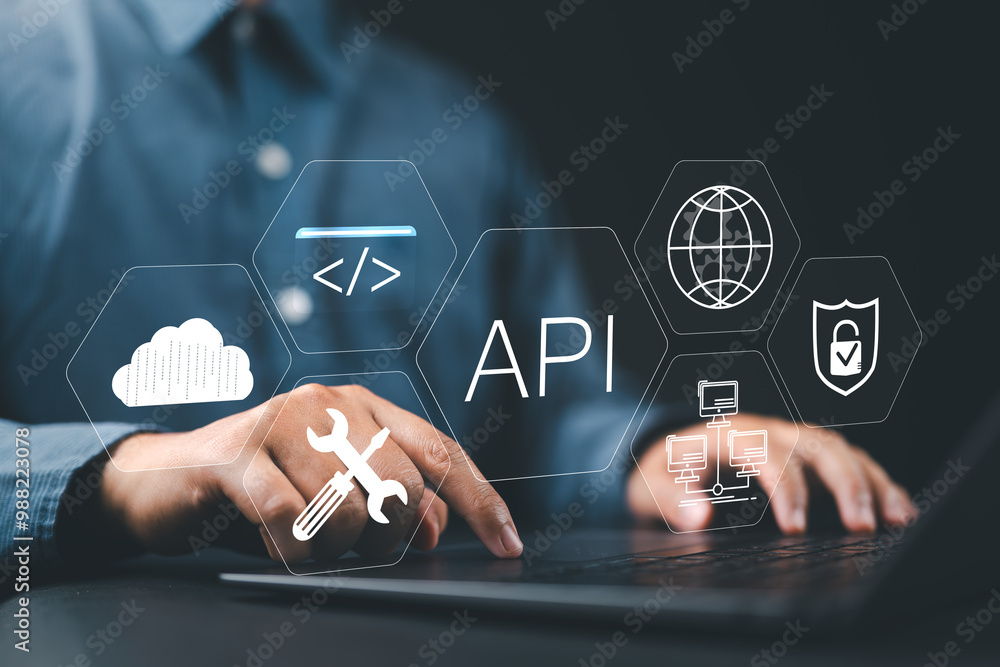 Aufkleber API Application Programming Interface Concept. A programmer types on a laptop, interacting with digital icons representing API development, security, and cloud computing. Application Software Tool,