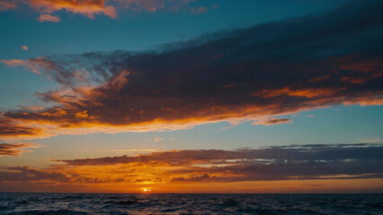 Sunset in front of the clouds the sky is over the salt water ocean