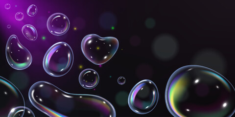 A banner design with rainbow soap bubbles of different shapes and sizes.