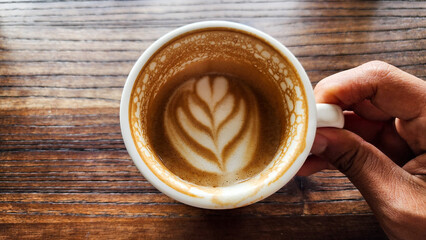 Top view latte art coffee on wood background