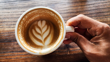Top view latte art coffee on wood background