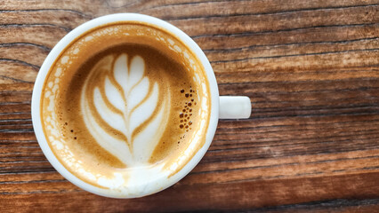 Top view latte art coffee on wood background