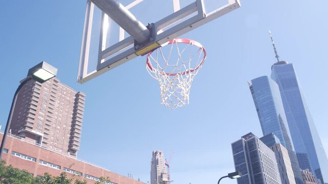 New York City World Trade Center skyscraper tower building, Manhattan Downtown Financial district, USA. Hudson River Park basketball court. Basket ball hoop and blackboard. Outdoor streetball sport.
