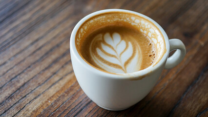 Top view latte art coffee on wood background