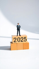 Fototapeta premium Businessman Standing on Wooden Blocks with 2025 Written on Them