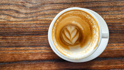 Top view latte art coffee on wood background