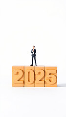 Miniature Businessman Standing on Wooden Blocks for 2025