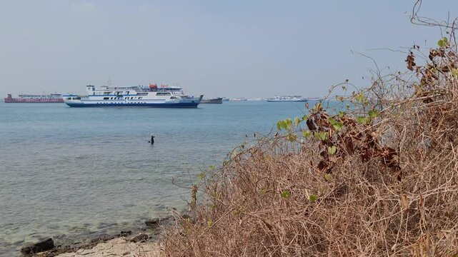 Merak, Indonesia on July 9 2023. A ferry ship with the code Ferizu is heading to the port of Merak.  The jargon of this ship is "We bridge the nation"